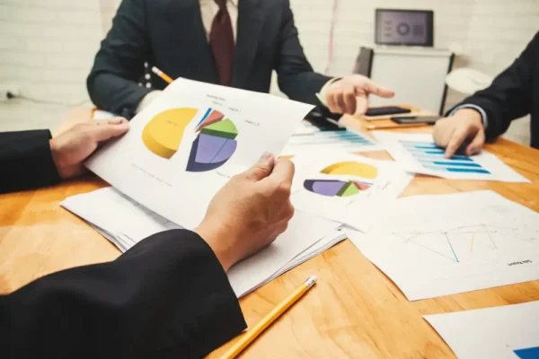 Professionals displaying financial infographics