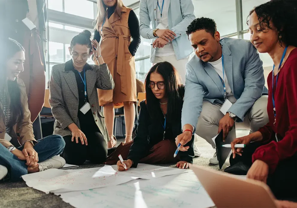 A diverse group of people participating in a creative brainstorming session during a seminar, discussing new ideas and strategies.