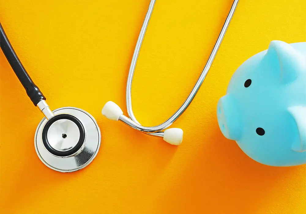Stethoscope and piggy bank. Represents healthcare costs and medical savings.