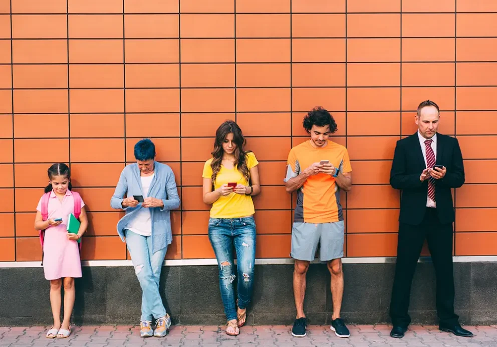 Five people at different ages texting separately.