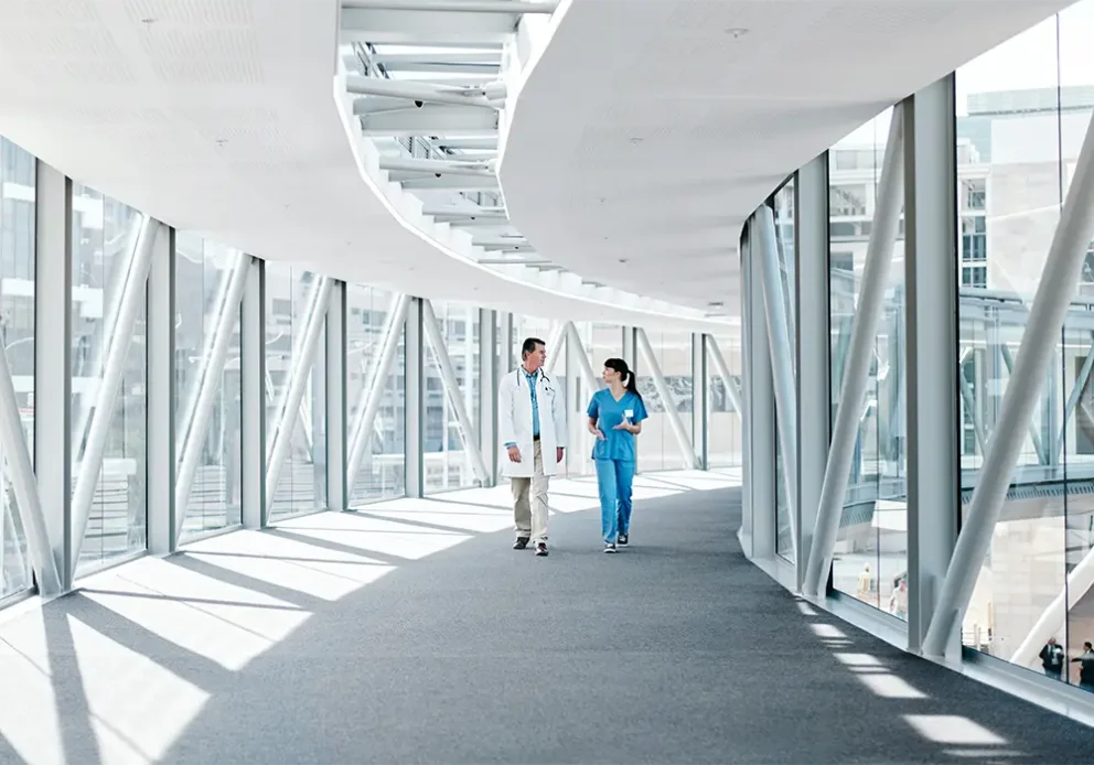 Shot of two healthcare workers walking together.