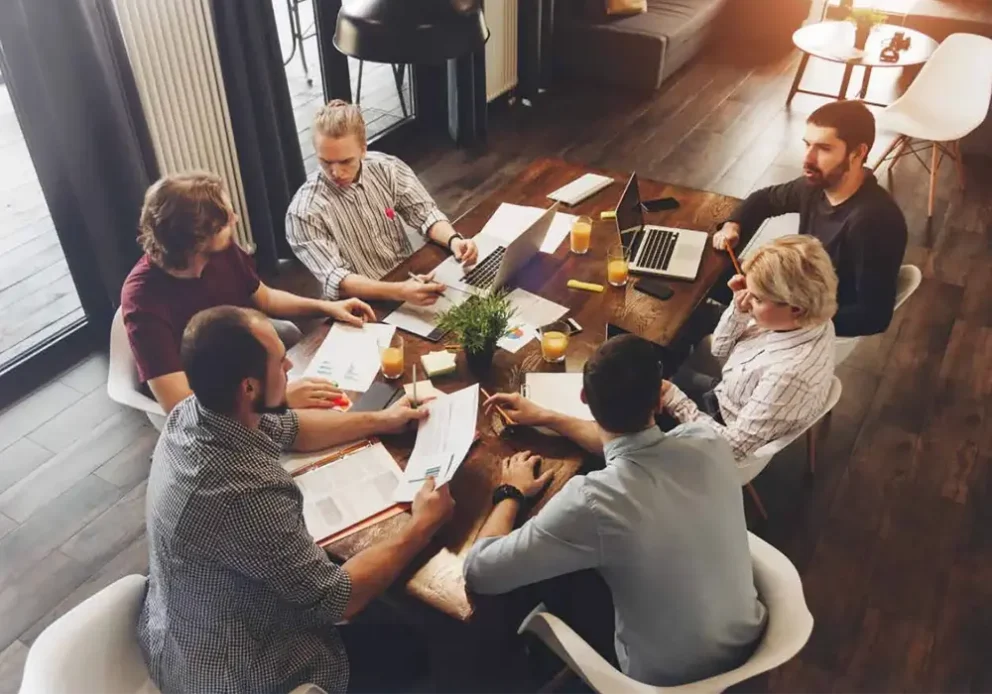Team meeting around a living room table